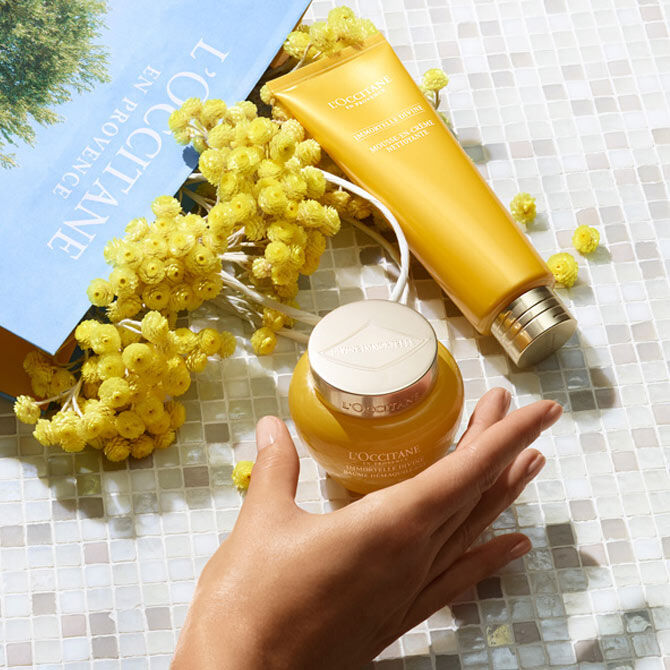 Divine cleansing balm and foaming cleanser next to l'occitane paper bag